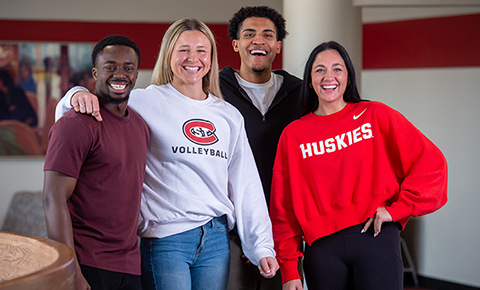 Four SCSU students pose for a photo together