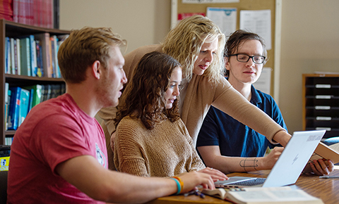 Students and faculty work on a computer at St. Cloud State University