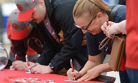 Fans fill out information cards at a St. Cloud State University event