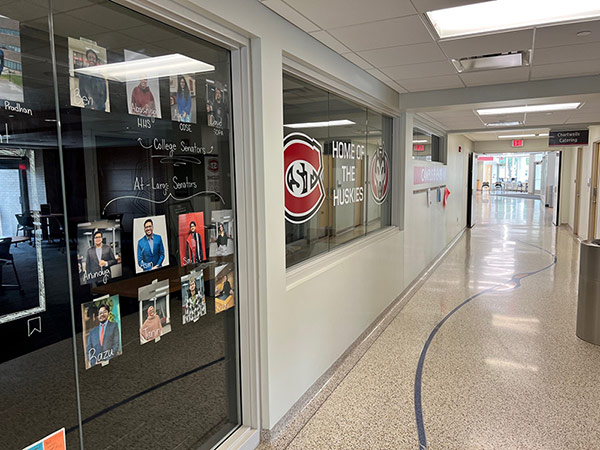 Main hallway in Atwood Memorial Center near the Student Government office with photos of students on a glass wall