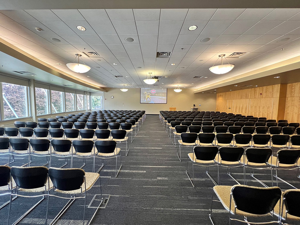 View from the back of the Cascade Room at Atwood Memorial Center looking down an open aisle with chairs on each side