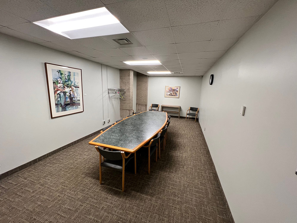 Interior of the Columbine Room at Atwood Memorial Center showing a large multipurpose space with carpeted floor, tables and chairs arranged for an event, and overhead lighting