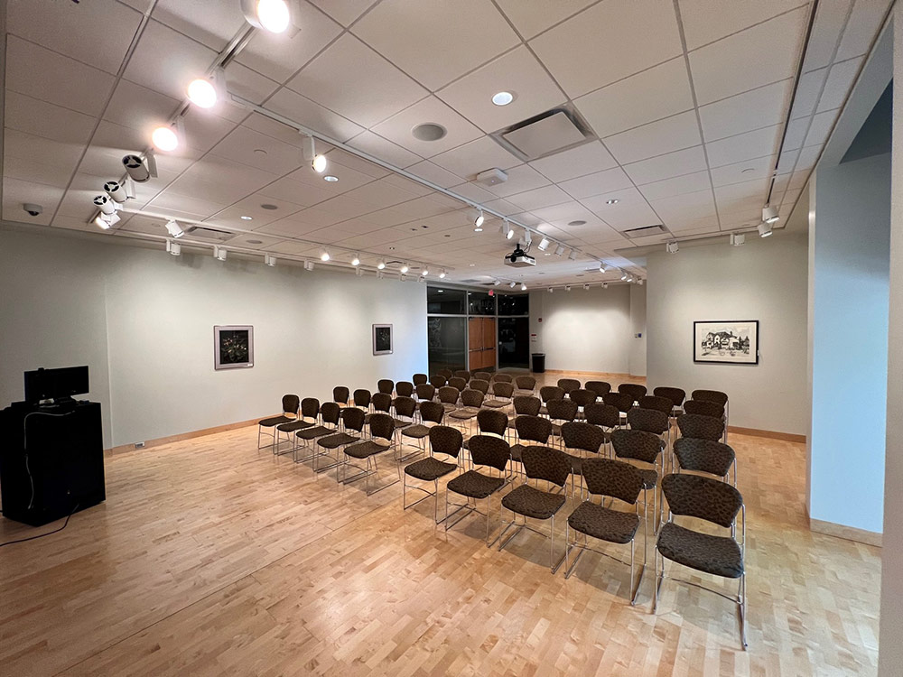 Gallery Room at Atwood Memorial Center from a different angle showing tables, chairs, and open floor space under gallery lighting
