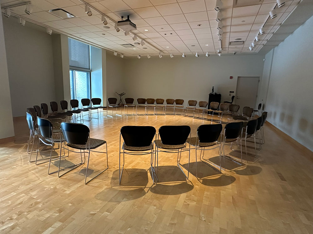 Interior of the Gallery Room at Atwood Memorial Center showing chairs arranged in a circular setup on a wood floor