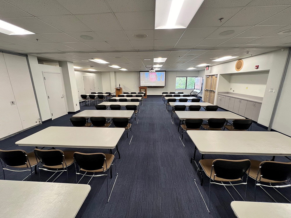 Interior of the Glacier Room at Atwood Memorial Center showing a meeting space with tables and chairs arranged for a group