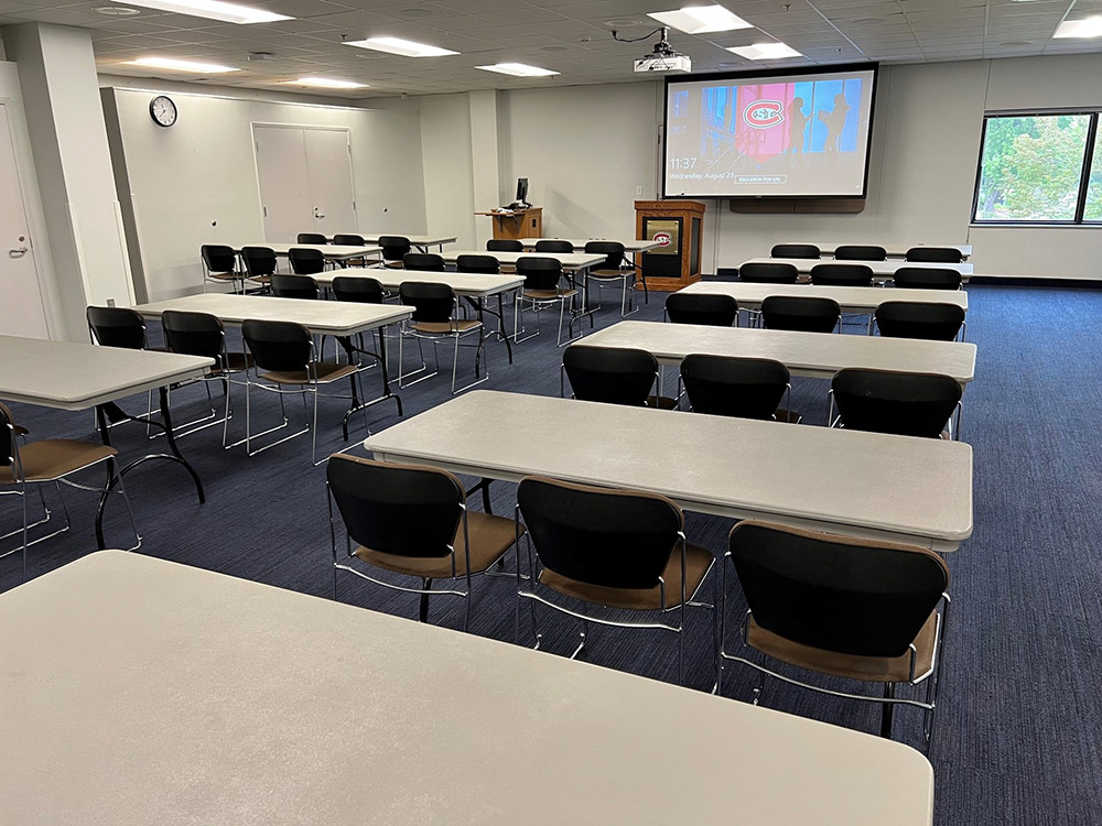 Glacier Room at Atwood Memorial Center from a different angle showing tables, chairs, and a presentation area