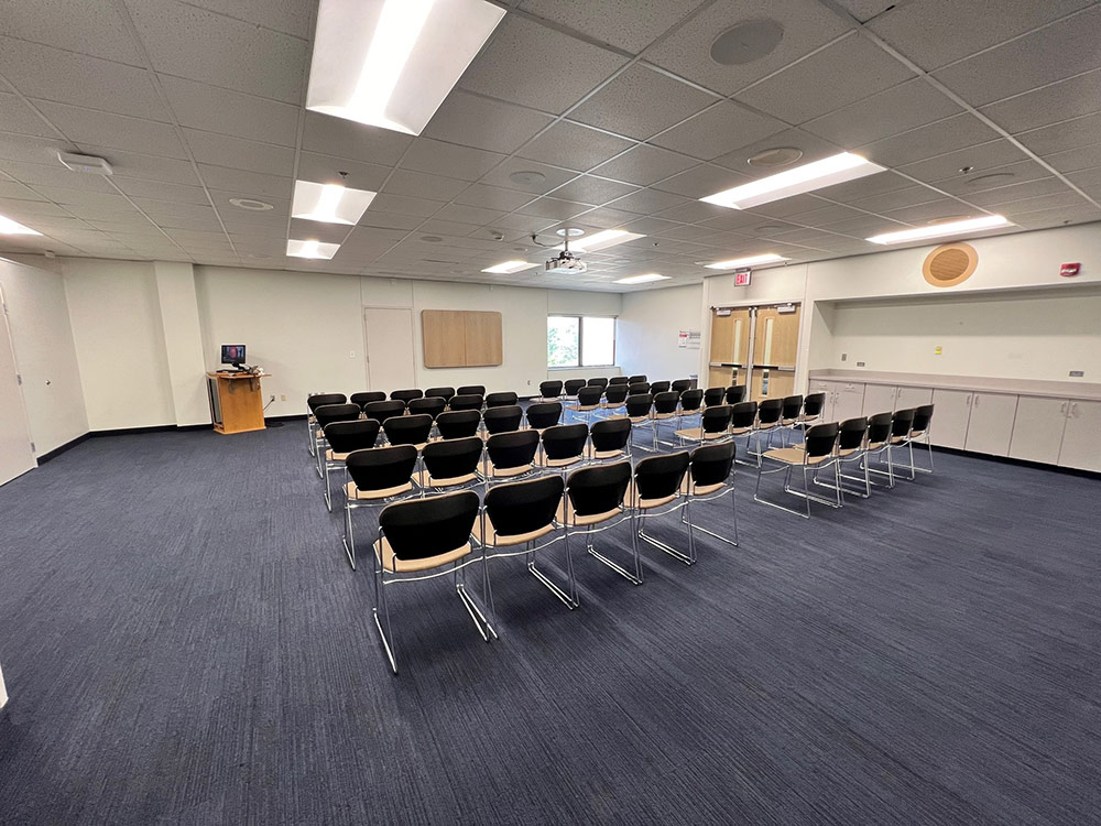 Glacier North Room at Atwood Memorial Center from a different angle showing tables, chairs, and a presentation area with built-in technology