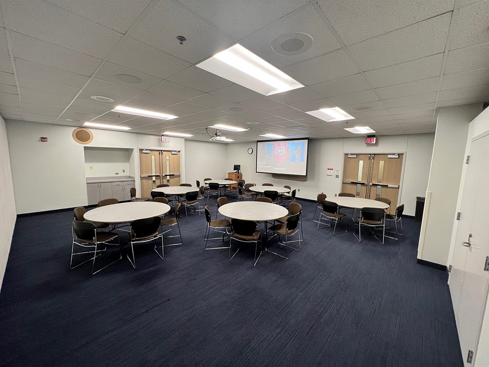 Glacier South Room at Atwood Memorial Center from a different angle showing tables, chairs, and a presentation area