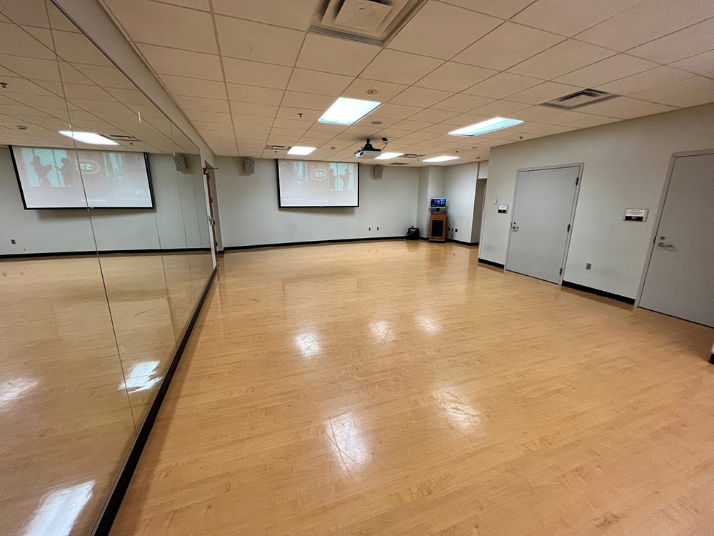 Studio Room viewed from the corner, showing the full length of mirrored walls and open practice space