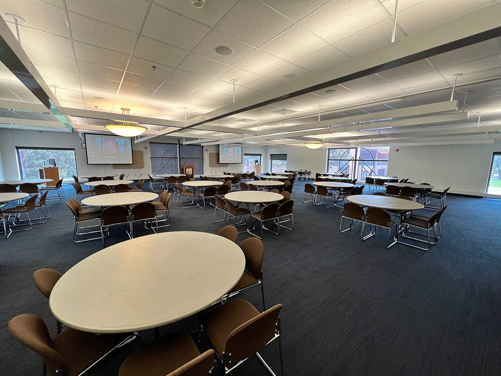 Interior of the Voyageurs Room at Atwood Memorial Center showing a meeting space with tables and chairs arranged for a group