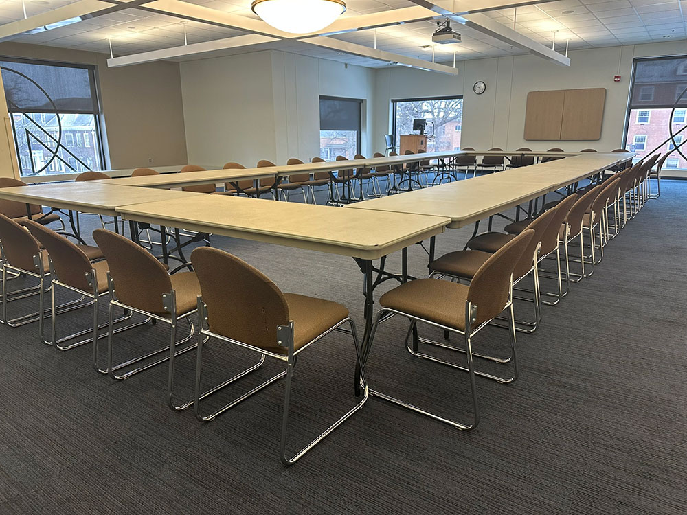 Interior of the Voyageurs North Room at Atwood Memorial Center showing multiple tables combined together with chairs arranged for a meeting