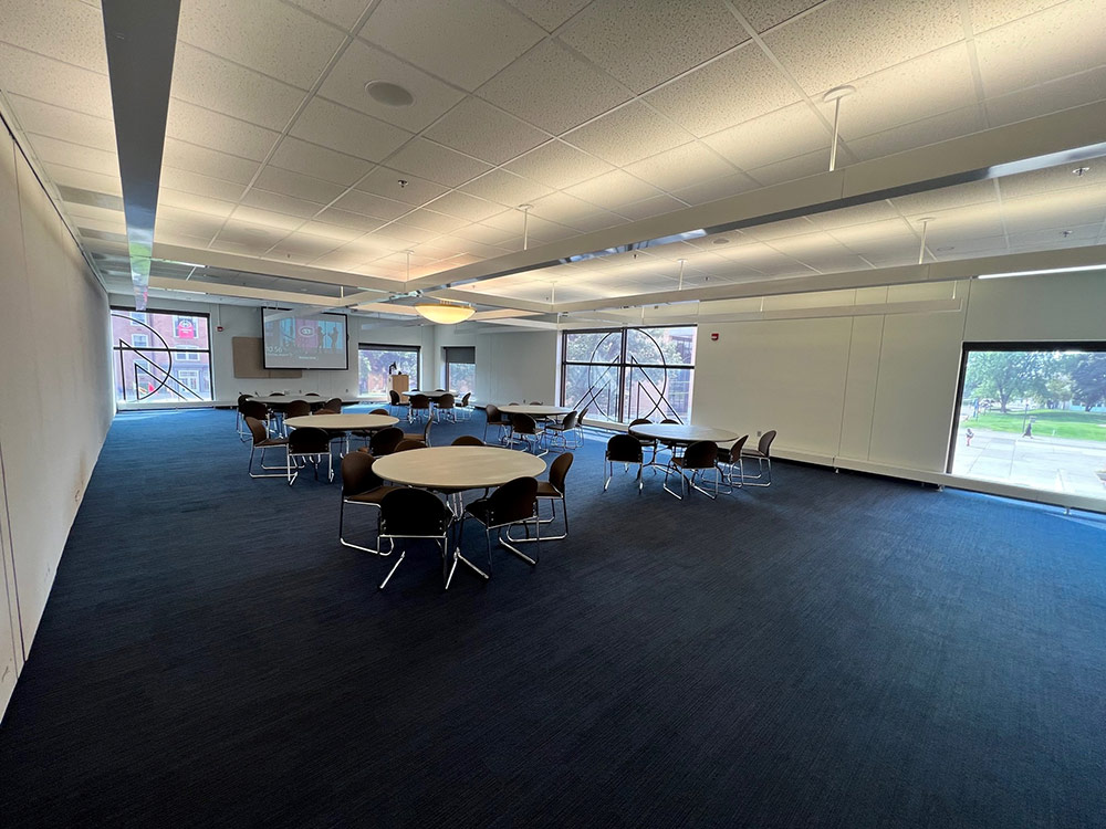 Interior of the Voyageurs South Room at Atwood Memorial Center showing tables and chairs arranged for a meeting or event