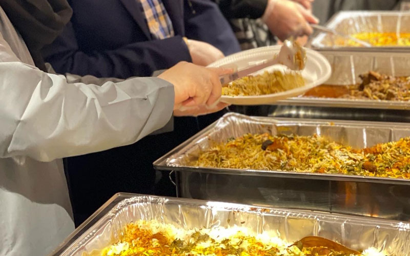 People putting cultural food on their plates during a Cultural Nights event