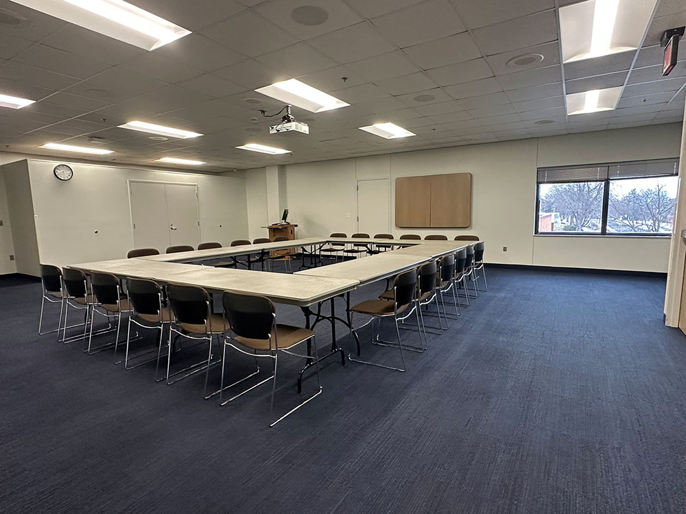 Interior of the Glacier North Room at Atwood Memorial Center showing multiple tables combined together with chairs arranged for a meeting