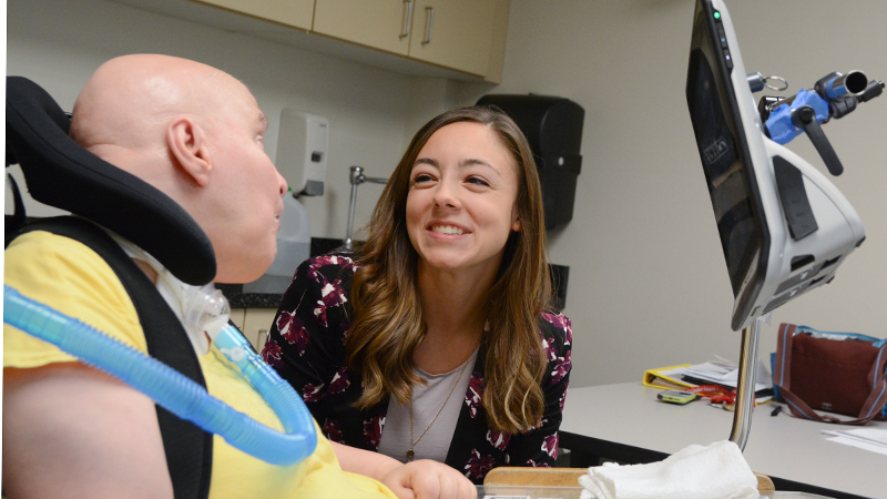 A student works with another person in a medical setting