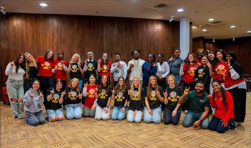 Group photo of Spring 2026 Nursing peer mentors, with most making the Husky hand gesture