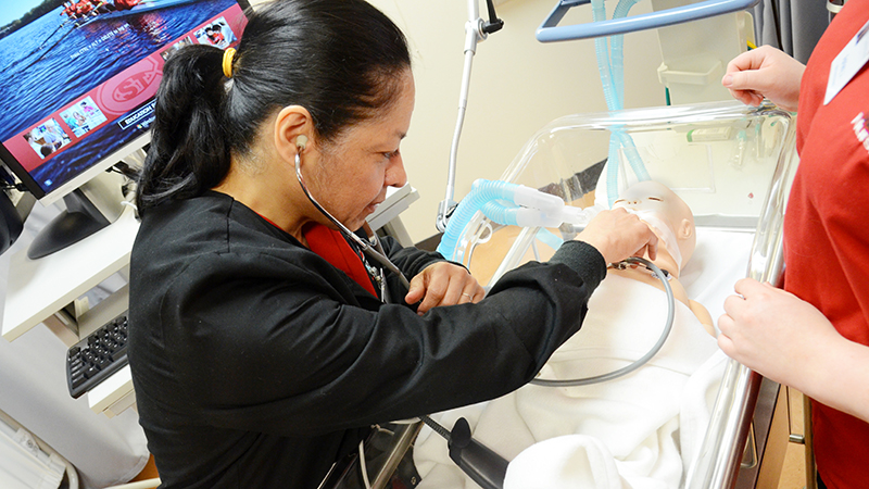 Nursing student participating in a patient care simulation