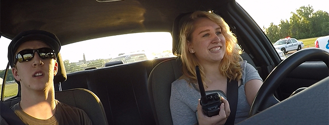 Teen receiving instructions on a walkie-talkie before a training exercise.